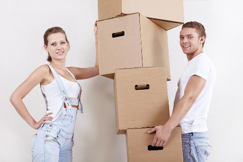 Mover carrying household items through a Staines apartment building